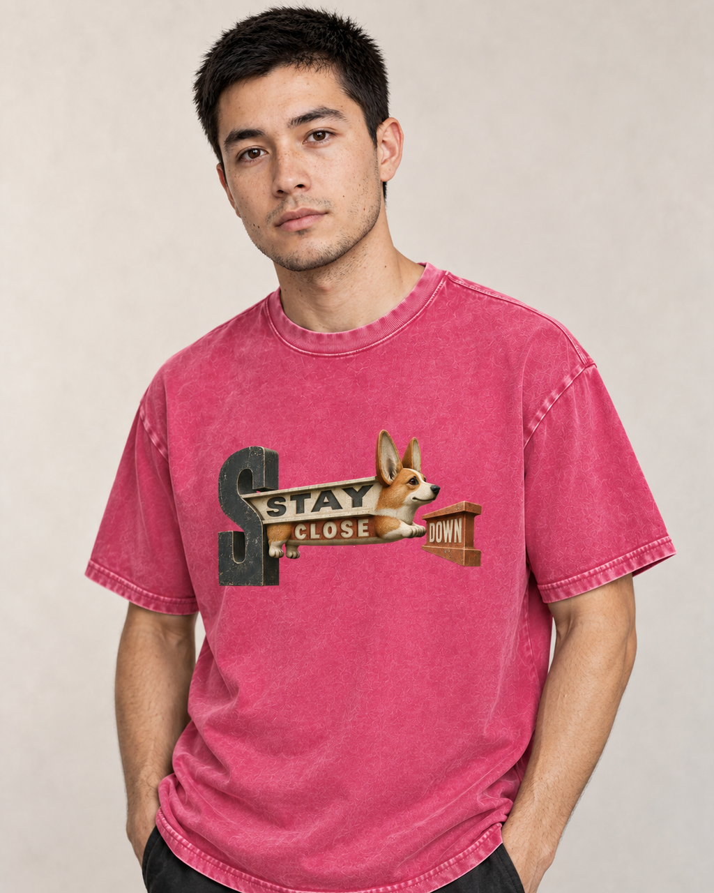 Adult model wears Fuchsia Corgi Stay Close Down Sign washed T-shirt in a side-angle editorial portrait