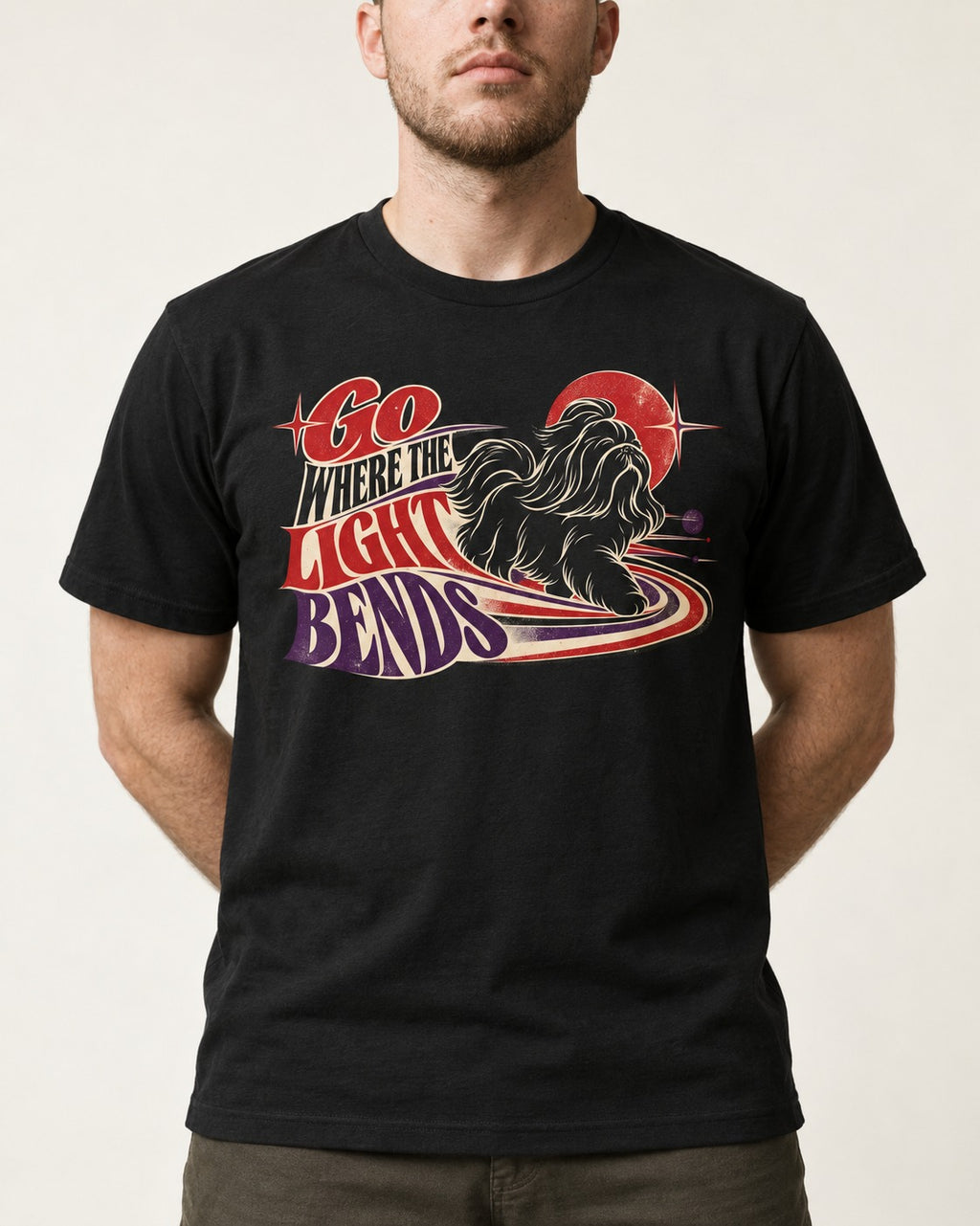 Shih Tzu Go Where the Light Bends Cosmic Orbit Graphic T-Shirt in Black, worn by a model, front view