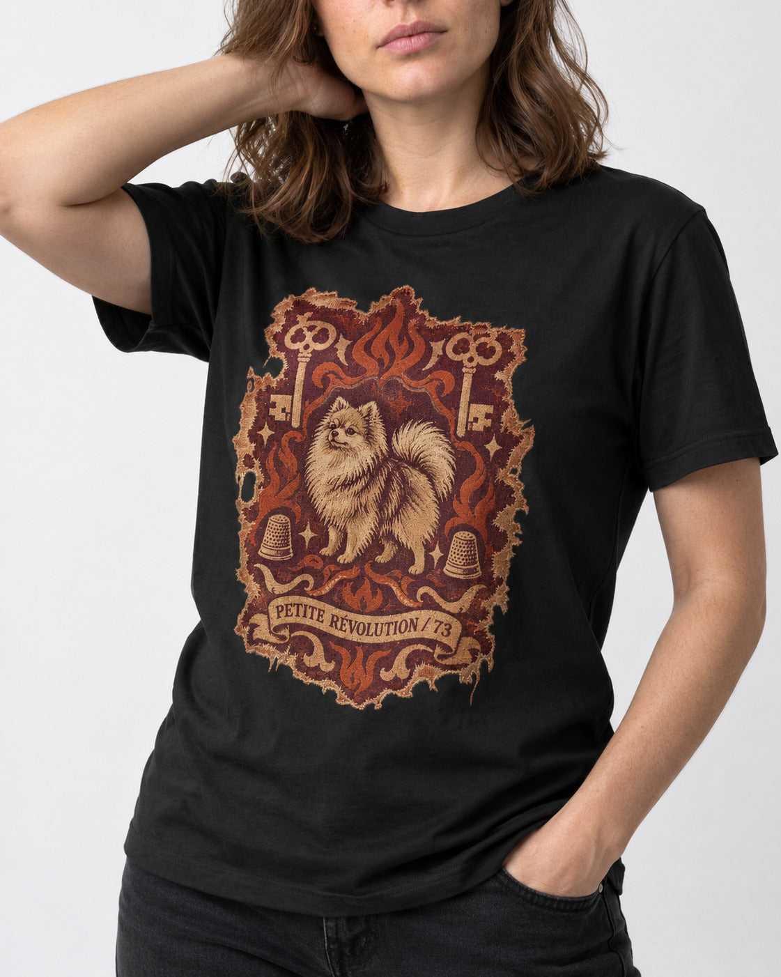 Pomeranian Petite Revolution Ornate Key Emblem Graphic T-Shirt in Black, worn by a model, front view