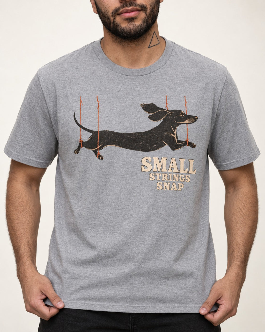Dachshund Small Strings Snap Marionette Graphic T-Shirt in Sport Grey, worn by a model, front view