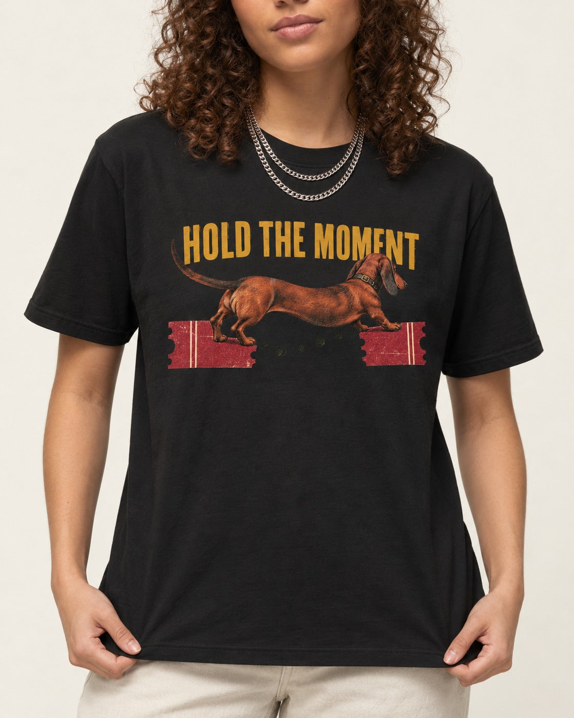 Dachshund Hold The Moment Torn Ticket Bridge Graphic T-Shirt in Black, worn by a model, front view
