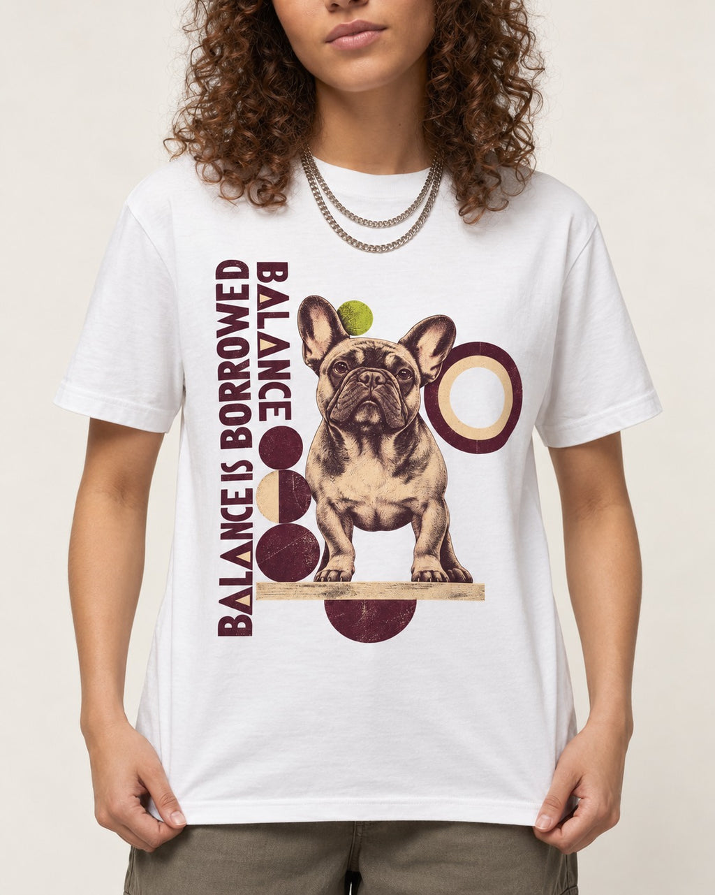 Frenchie's Balance Is Borrowed T-Shirt in White, worn by a model, front view