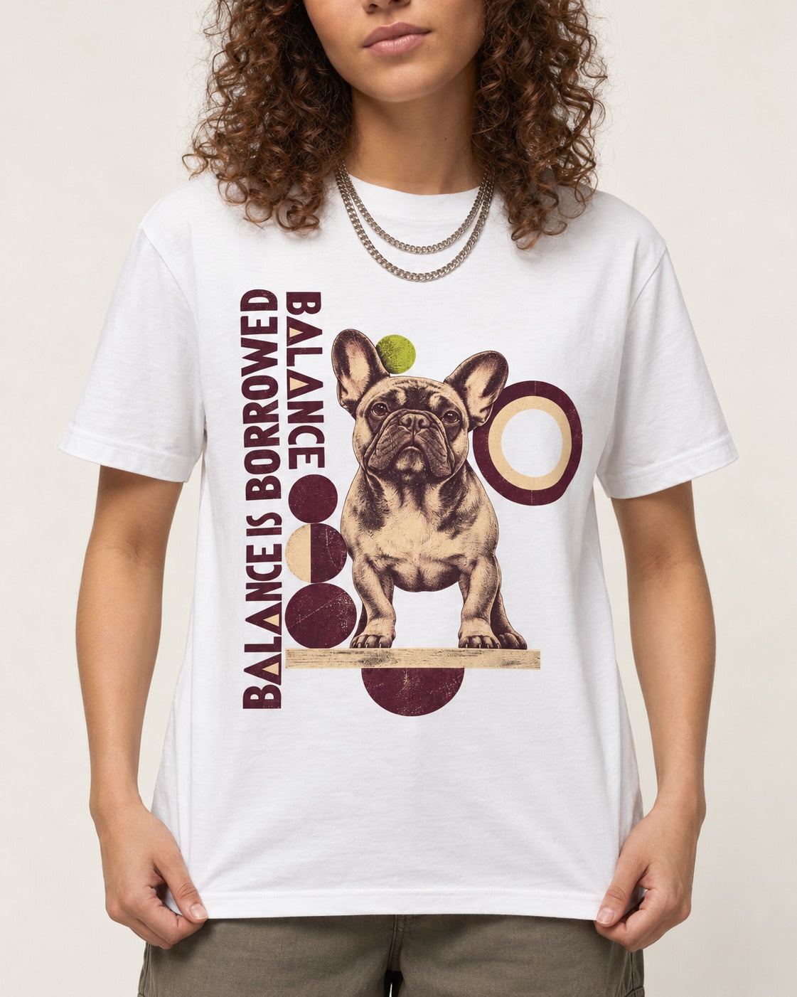 Frenchie's Balance Is Borrowed T-Shirt in White, worn by a model, front view