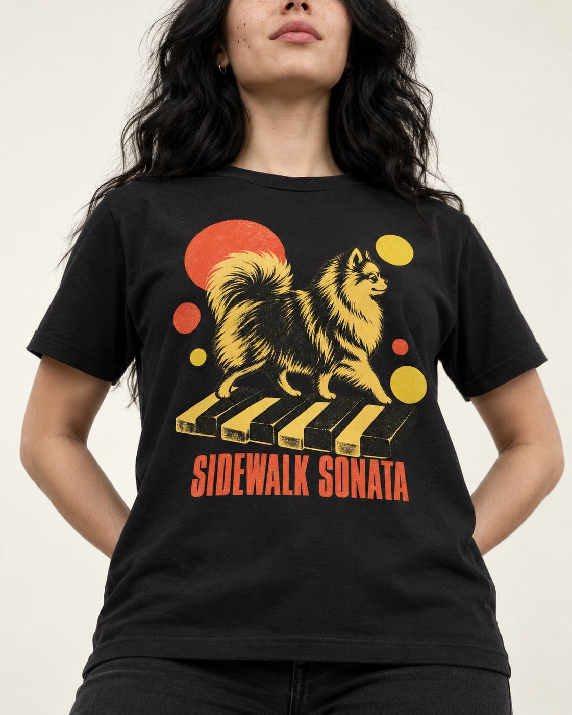 Pomeranian Sidewalk Sonata Piano Graphic T-Shirt in Black, worn by a model, front view