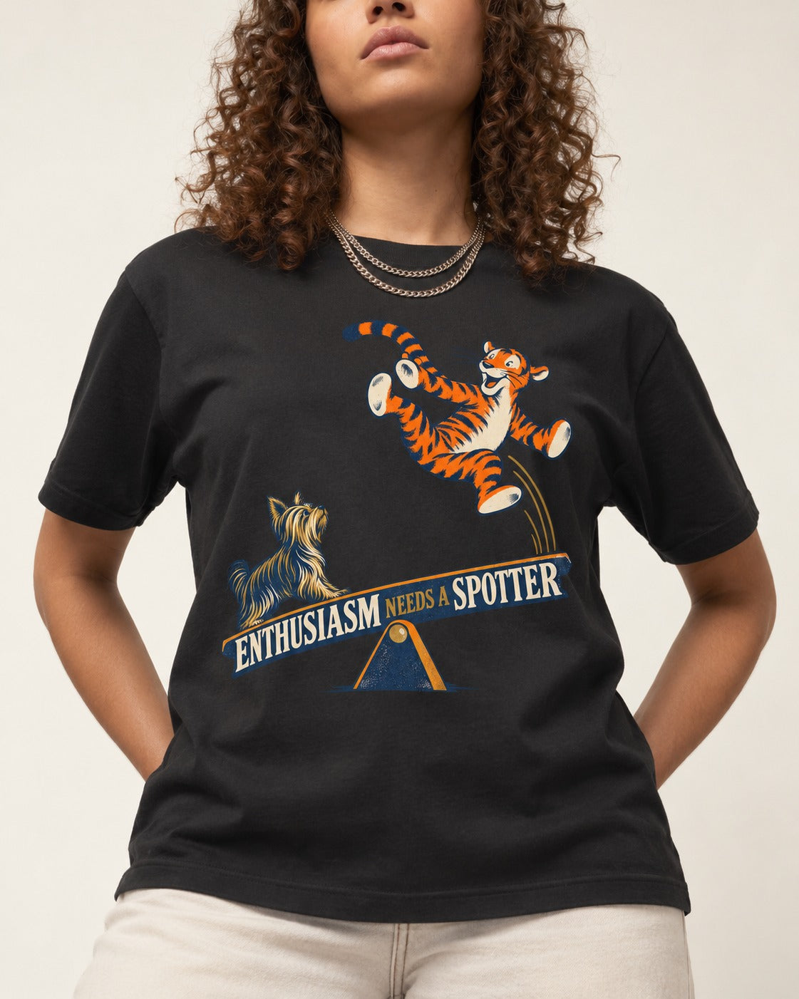 Yorkshire Terrier Enthusiasm Needs a Spotter Seesaw Graphic T-Shirt in Black, worn by a model, front view