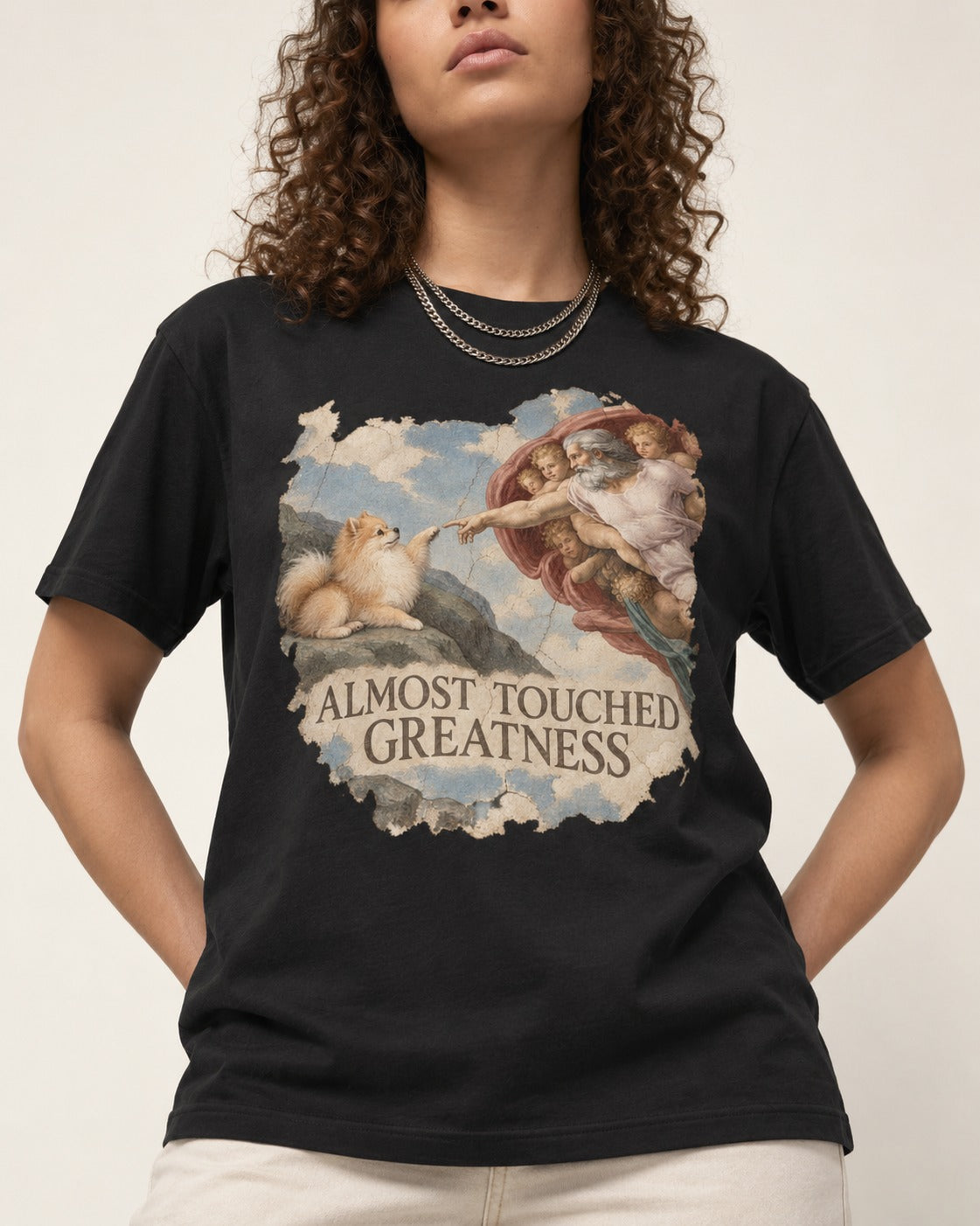 Pomeranian Almost Touched Greatness Fresco Graphic T-Shirt in Black, worn by a model, front view
