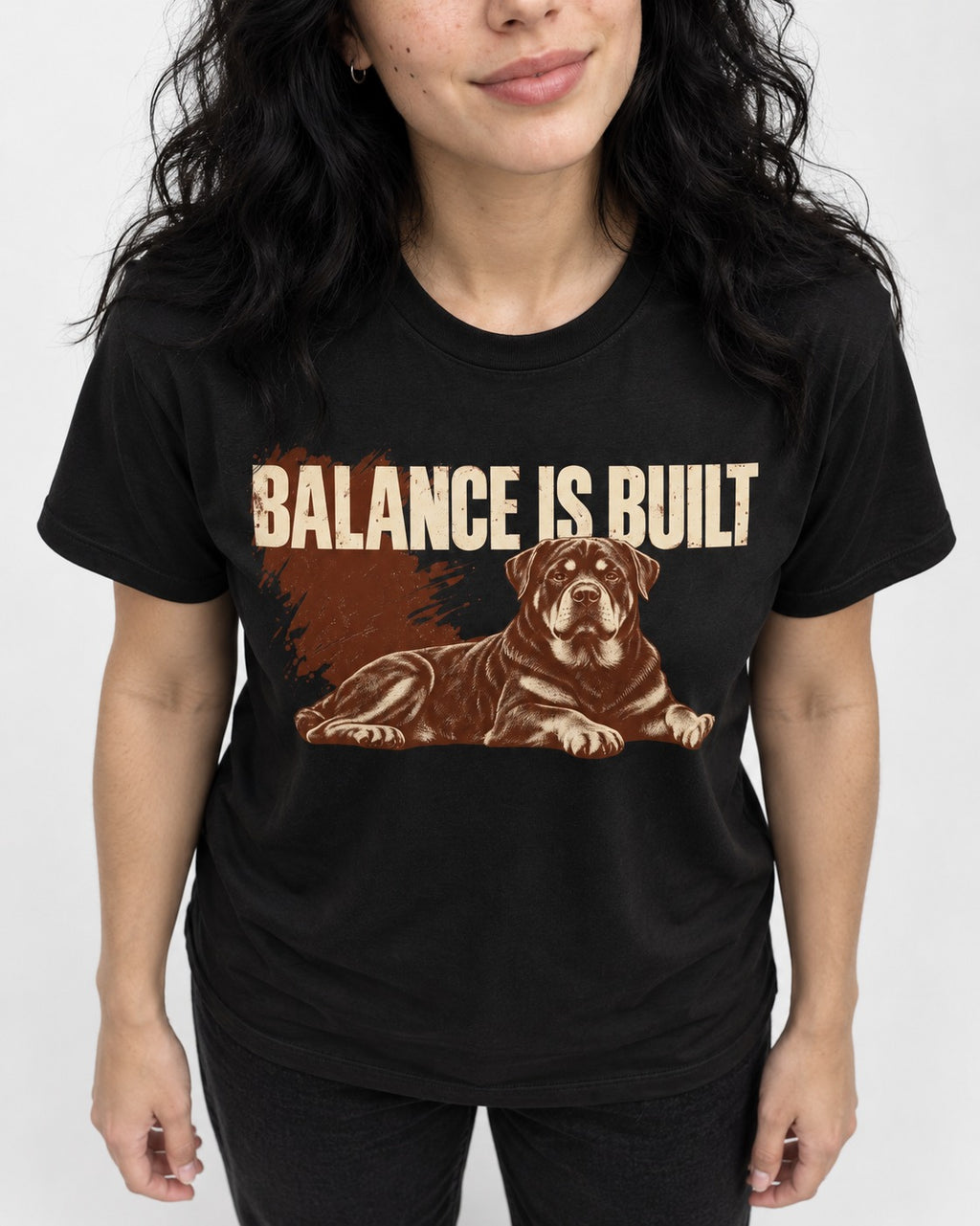 Rottweiler Balance Is Built Resting Strength Graphic T-Shirt in Black, worn by a model, front view