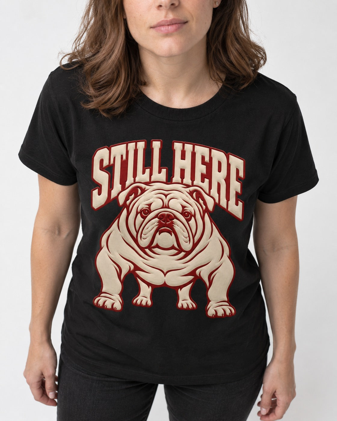 English Bulldog Still Here Collegiate Graphic T-Shirt in Black, worn by a model, front view