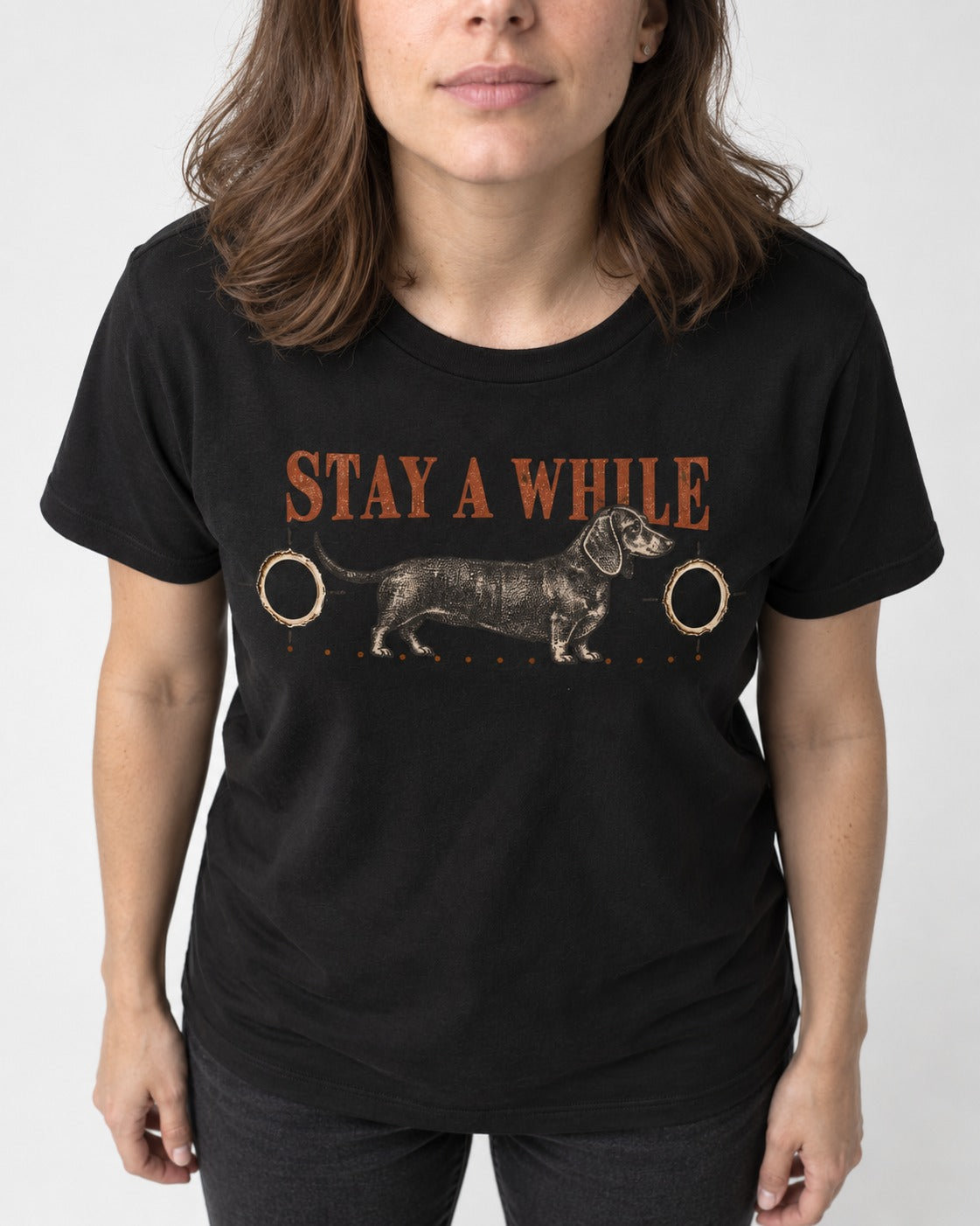 Dachshund Stay A While Ornamental Portrait Graphic T-Shirt in Black, worn by a model, front view