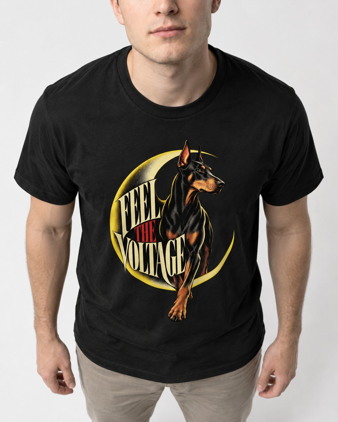Doberman Feel the Voltage Crescent Portrait Graphic T-Shirt in Black, worn by a model, front view