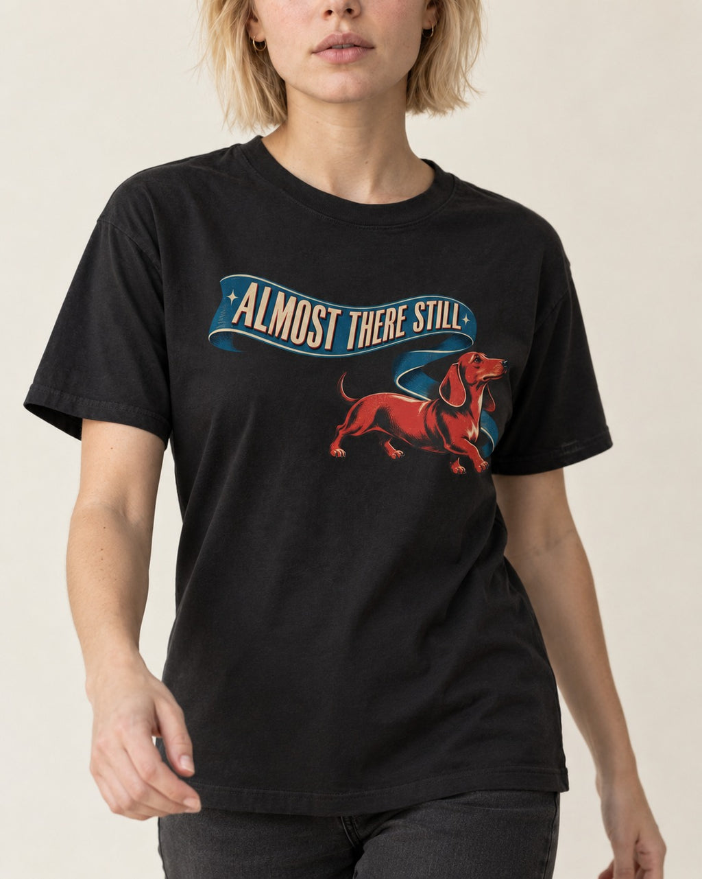 Dachshund Almost There Still Ribbon Graphic T-Shirt in Black, worn by a model, front view