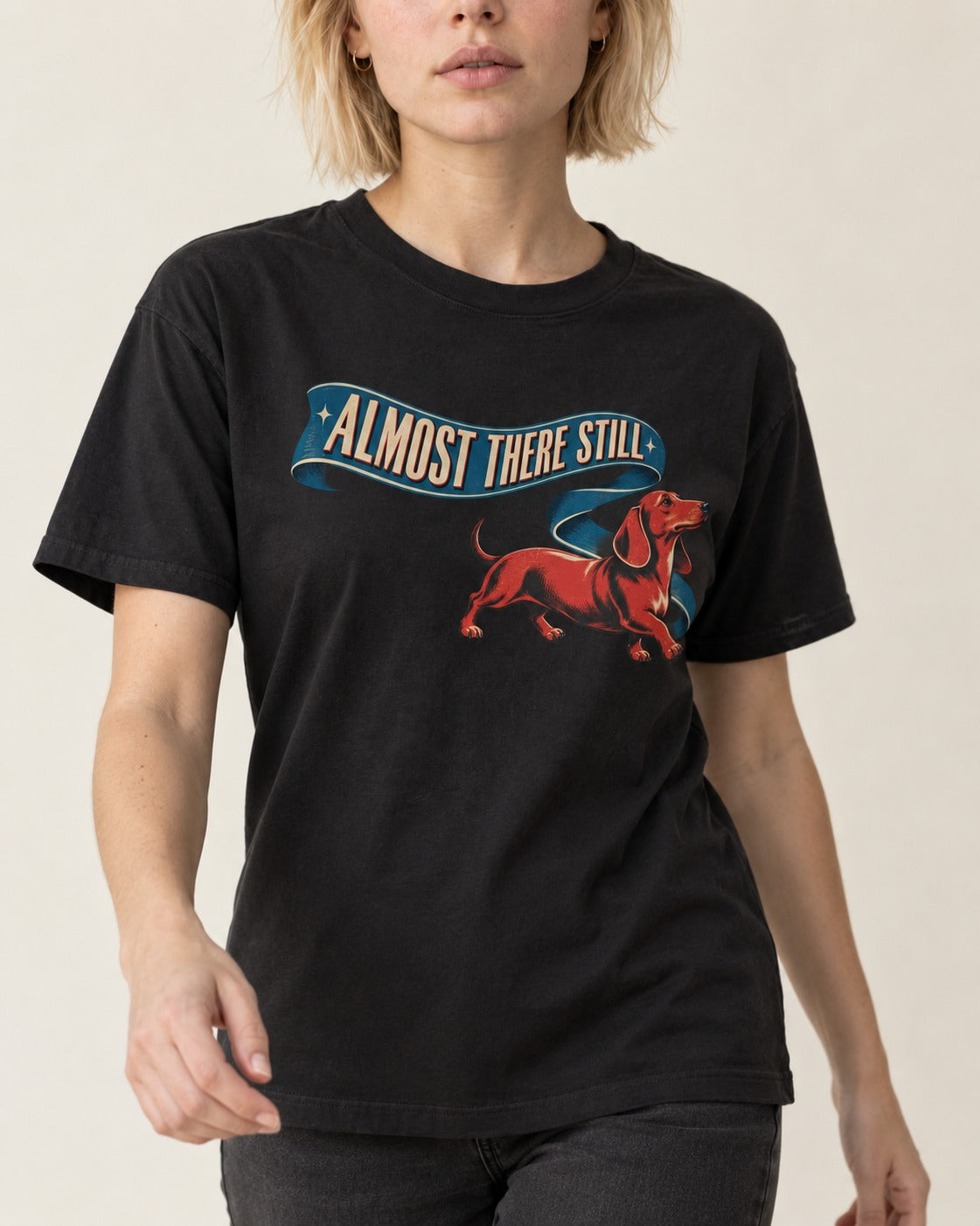 Dachshund Almost There Still Ribbon Graphic T-Shirt in Black, worn by a model, front view