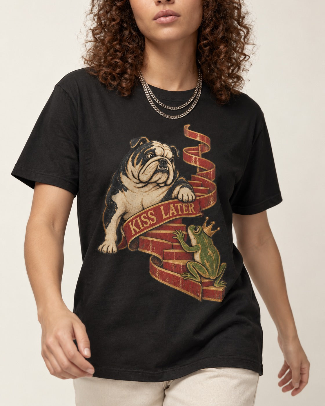 English Bulldog Kiss Later Frog Prince Graphic T-Shirt in Black, worn by a model, front view