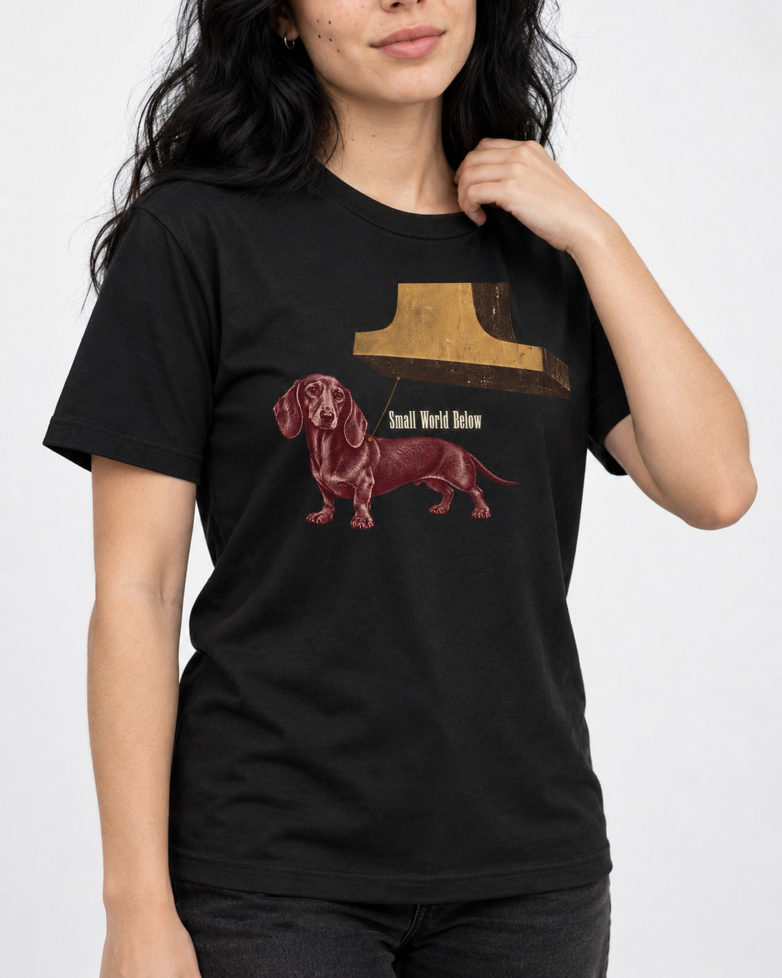 Dachshund Small World Below Giant Shoe Graphic T-Shirt in Black, worn by a model, front view