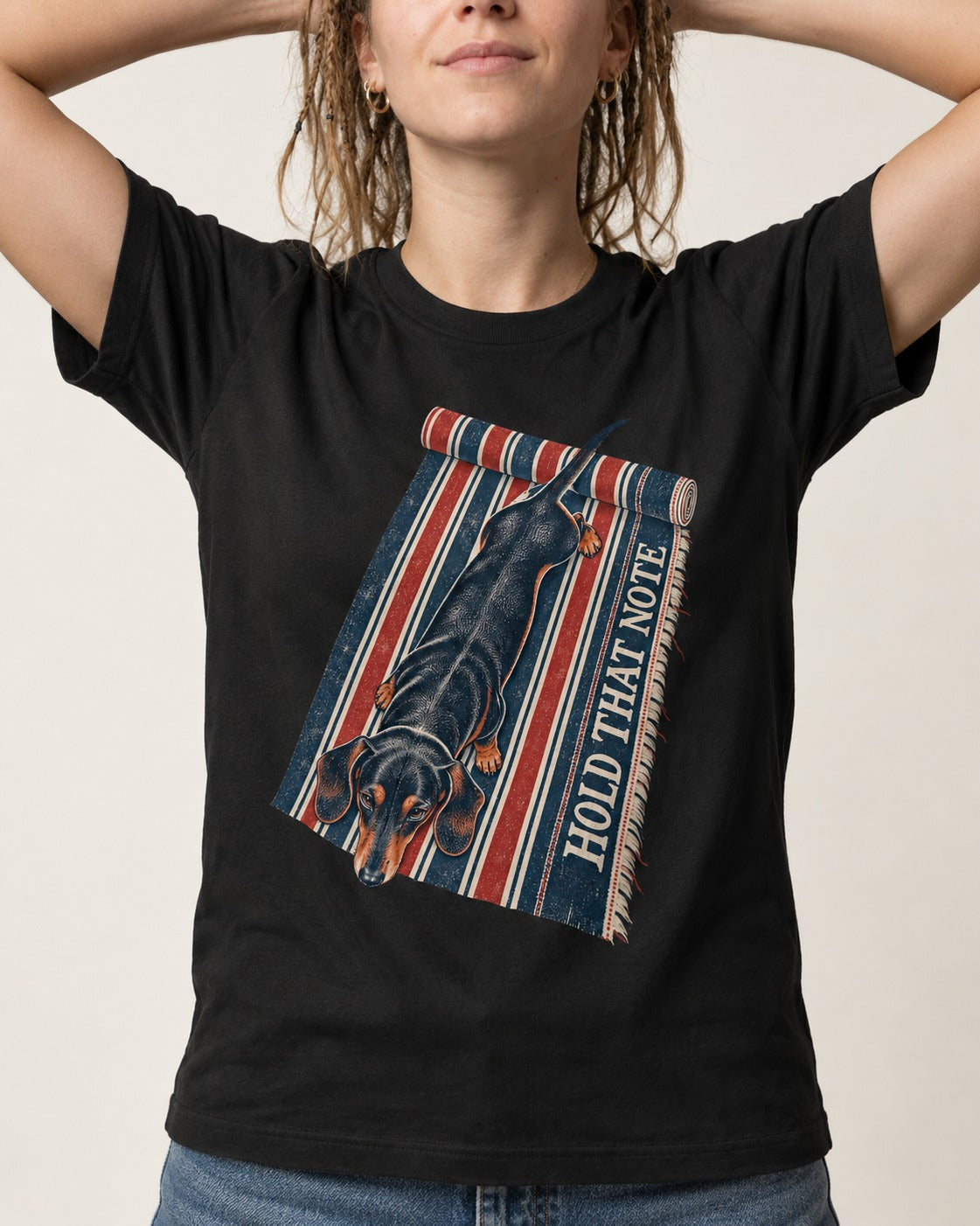 Dachshund Hold That Note Striped Rug Graphic T-Shirt in Black, worn by a model, front view