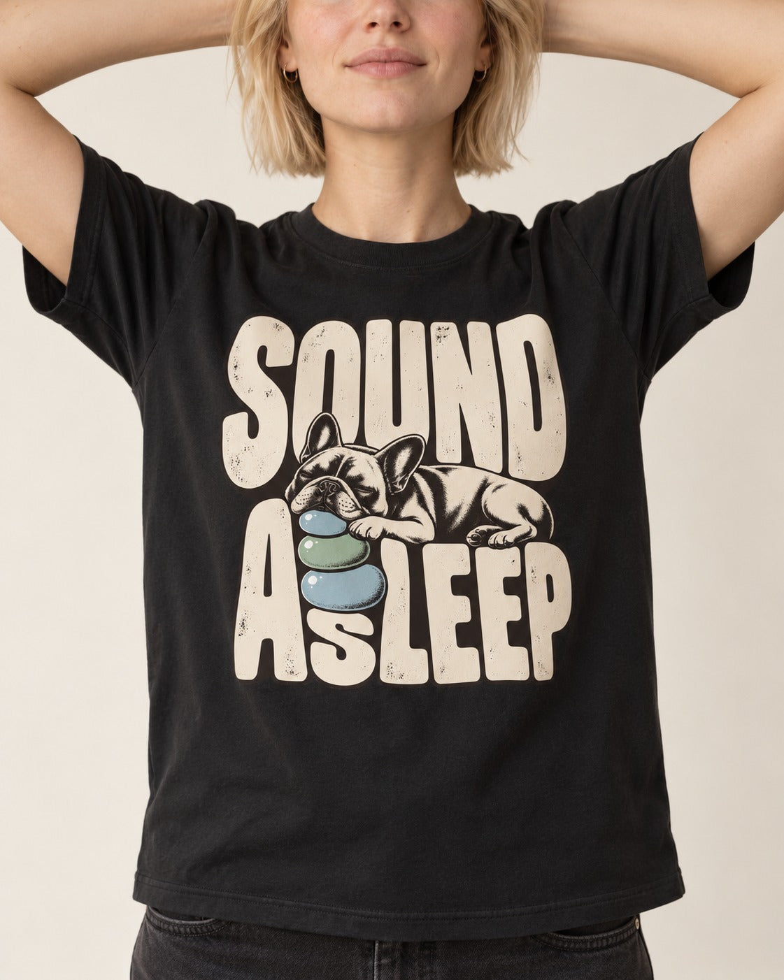 Frenchie Sound Asleep Stone Pillow Graphic T-Shirt in Black, worn by a model, front view