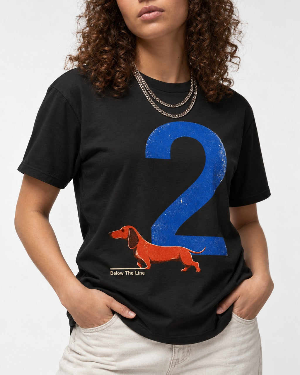 Dachshund Below The Line Number Two Graphic T-Shirt in Black, worn by a model, front view
