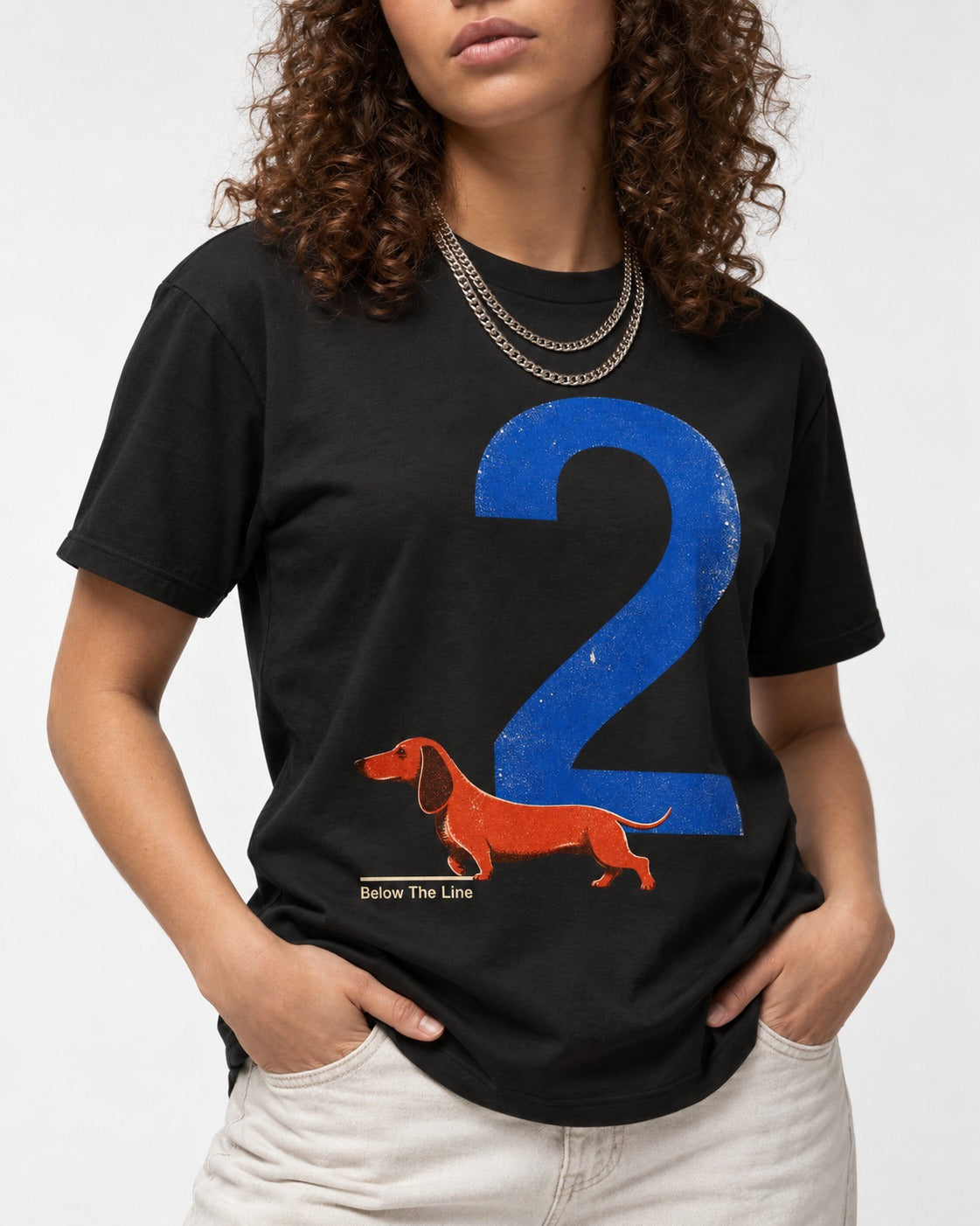 Dachshund Below The Line Number Two Graphic T-Shirt in Black, worn by a model, front view