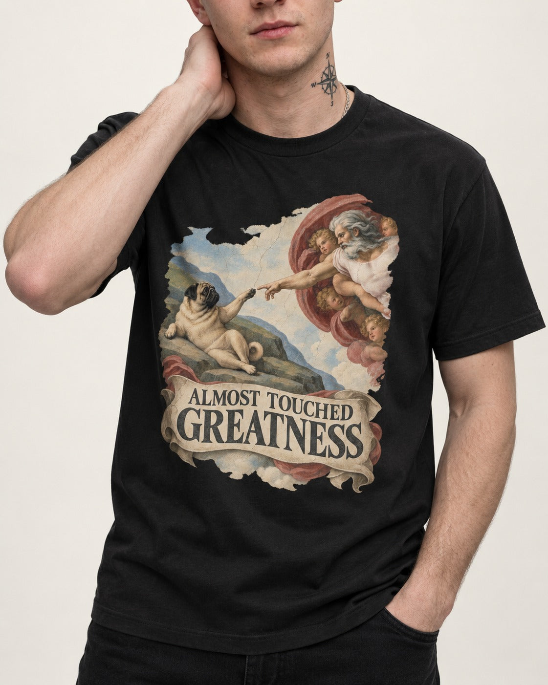 Pug Almost Touched Greatness Creation Parody Graphic T-Shirt in Black, worn by a model, front view