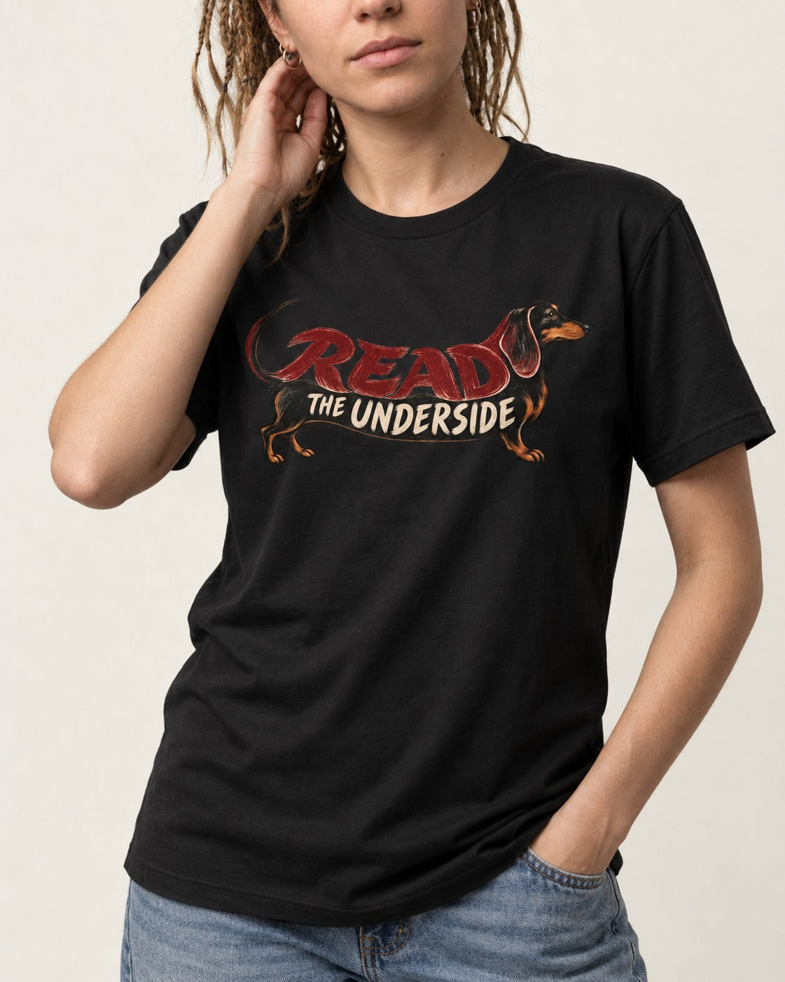 Dachshund Read The Underside Body Lettering Graphic T-Shirt in Black, worn by a model, front view