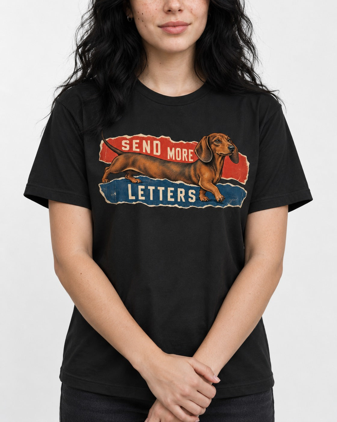 Dachshund Send More Letters Torn Paper Graphic T-Shirt in Black, worn by a model, front view