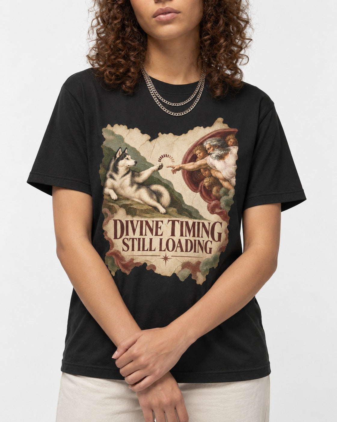 Husky Divine Timing Still Loading Creation Parody Graphic T-Shirt in Black, worn by a model, front view