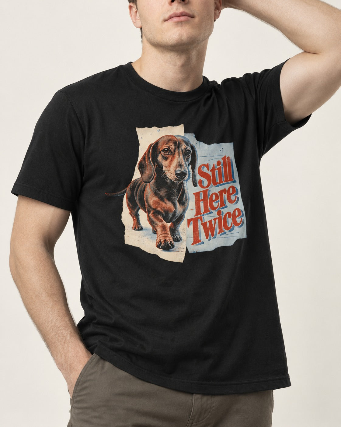 Dachshund Still Here Twice Torn Paper Graphic T-Shirt in Black, worn by a model, front view