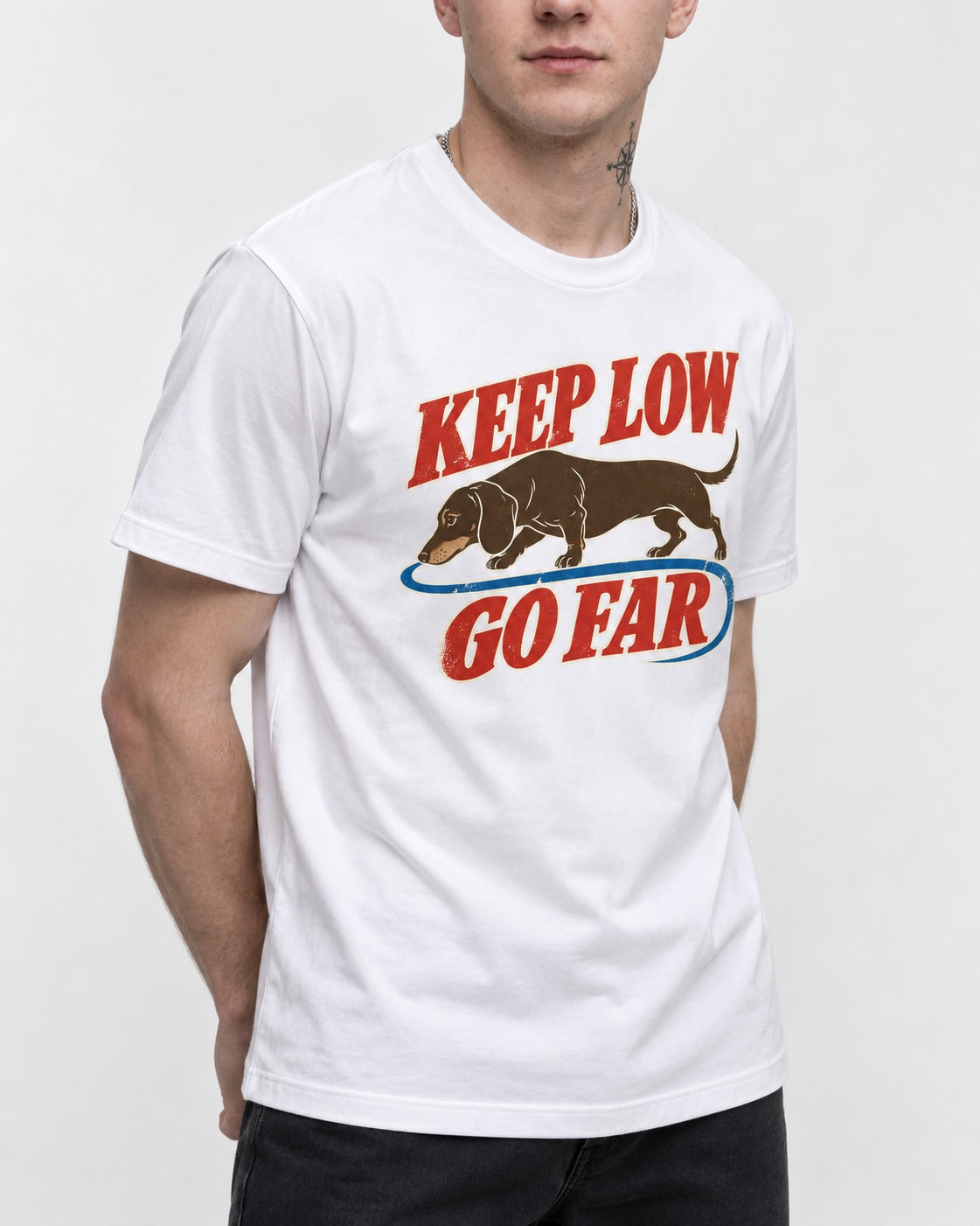 Dachshund Keep Low Go Far T-Shirt in White, worn by a model, front view