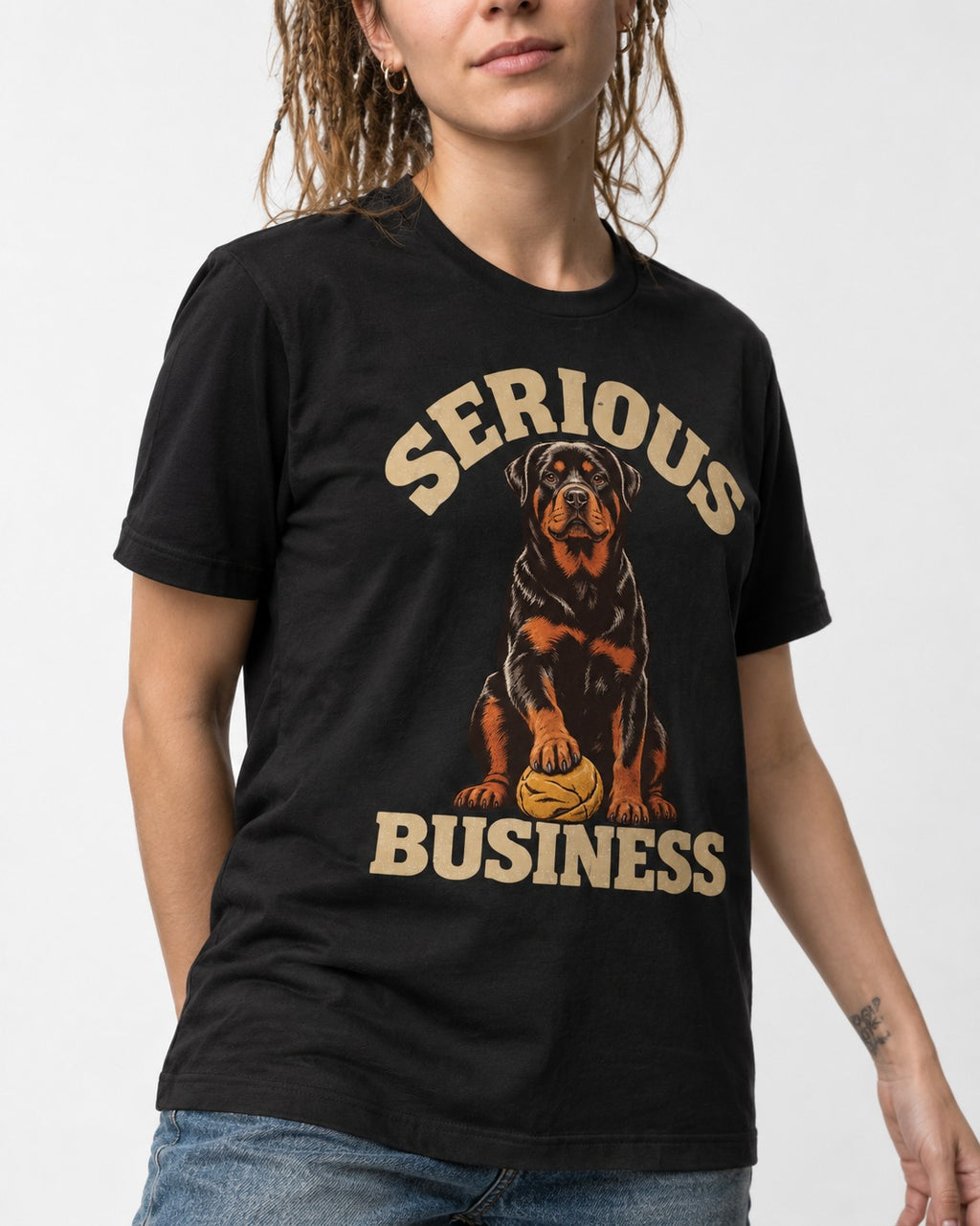 Rottweiler Serious Business Ball Under Paw Graphic T-Shirt in Black, worn by a model, front view