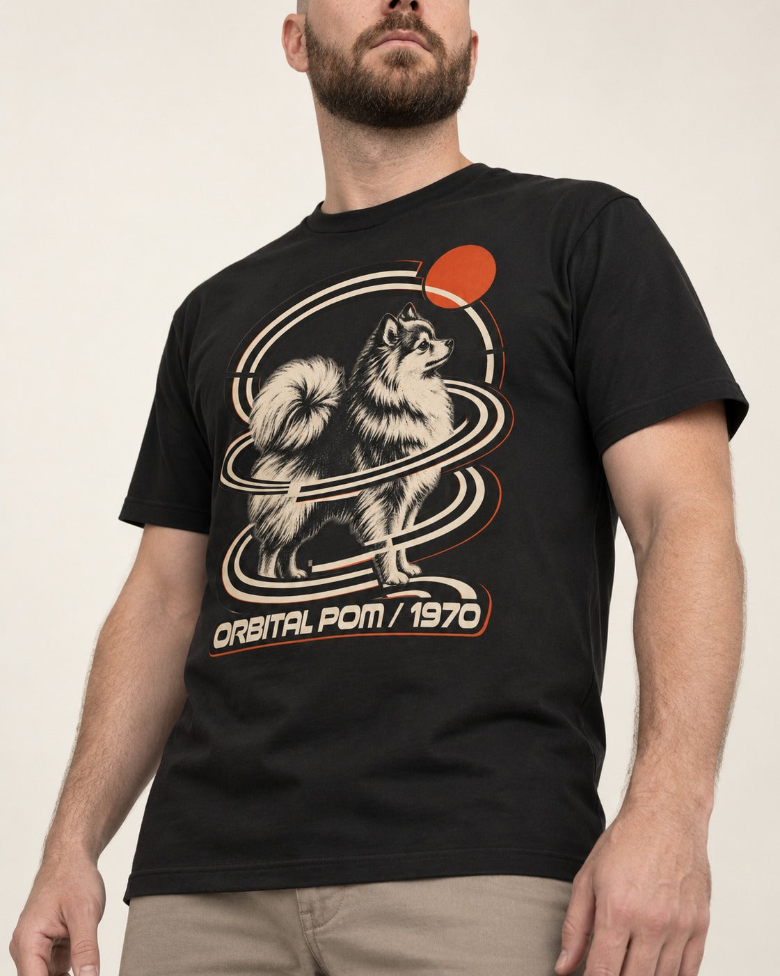 Pomeranian Orbital Pom 1970 Space Age Graphic T-Shirt in Black, worn by a model, front view