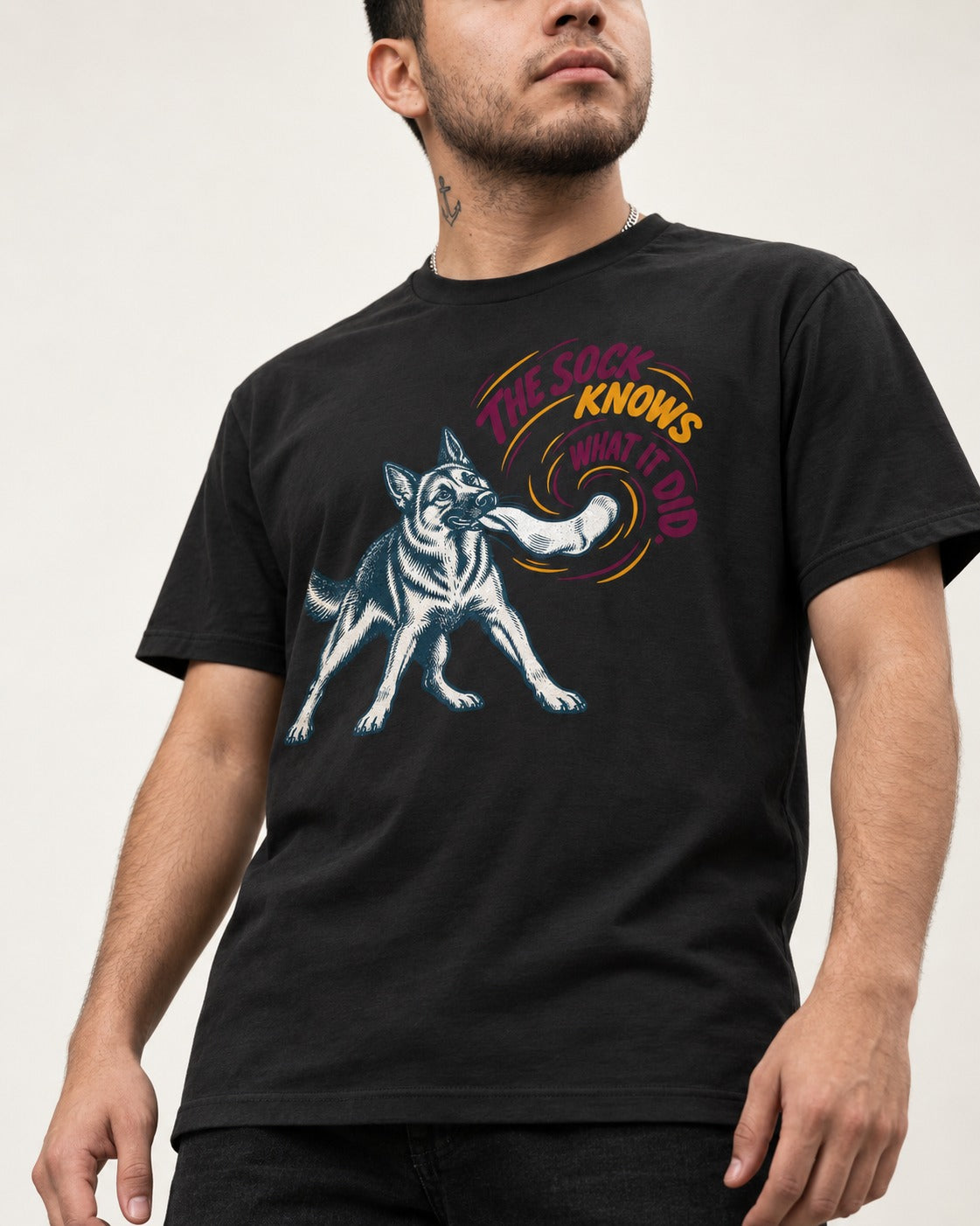 German Shepherd Dog The Sock Knows What I Did Graphic T-Shirt in Black, worn by a model, front view