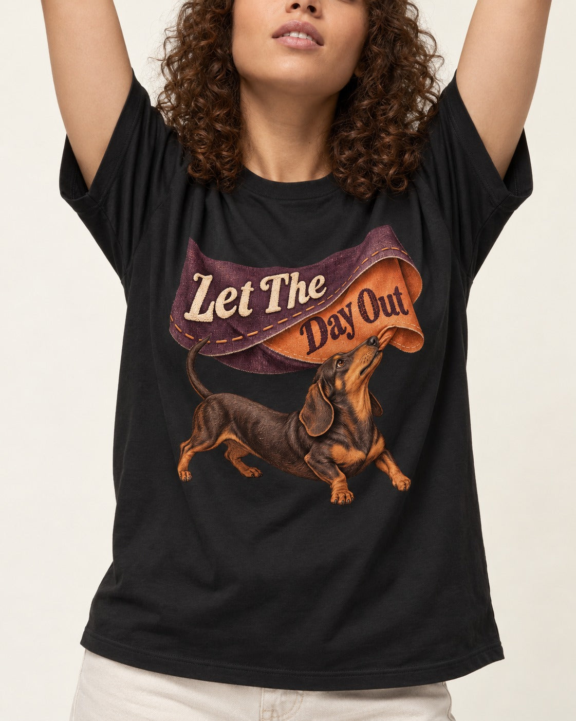 Dachshund Let The Day Out Fabric Banner Graphic T-Shirt in Black, worn by a model, front view