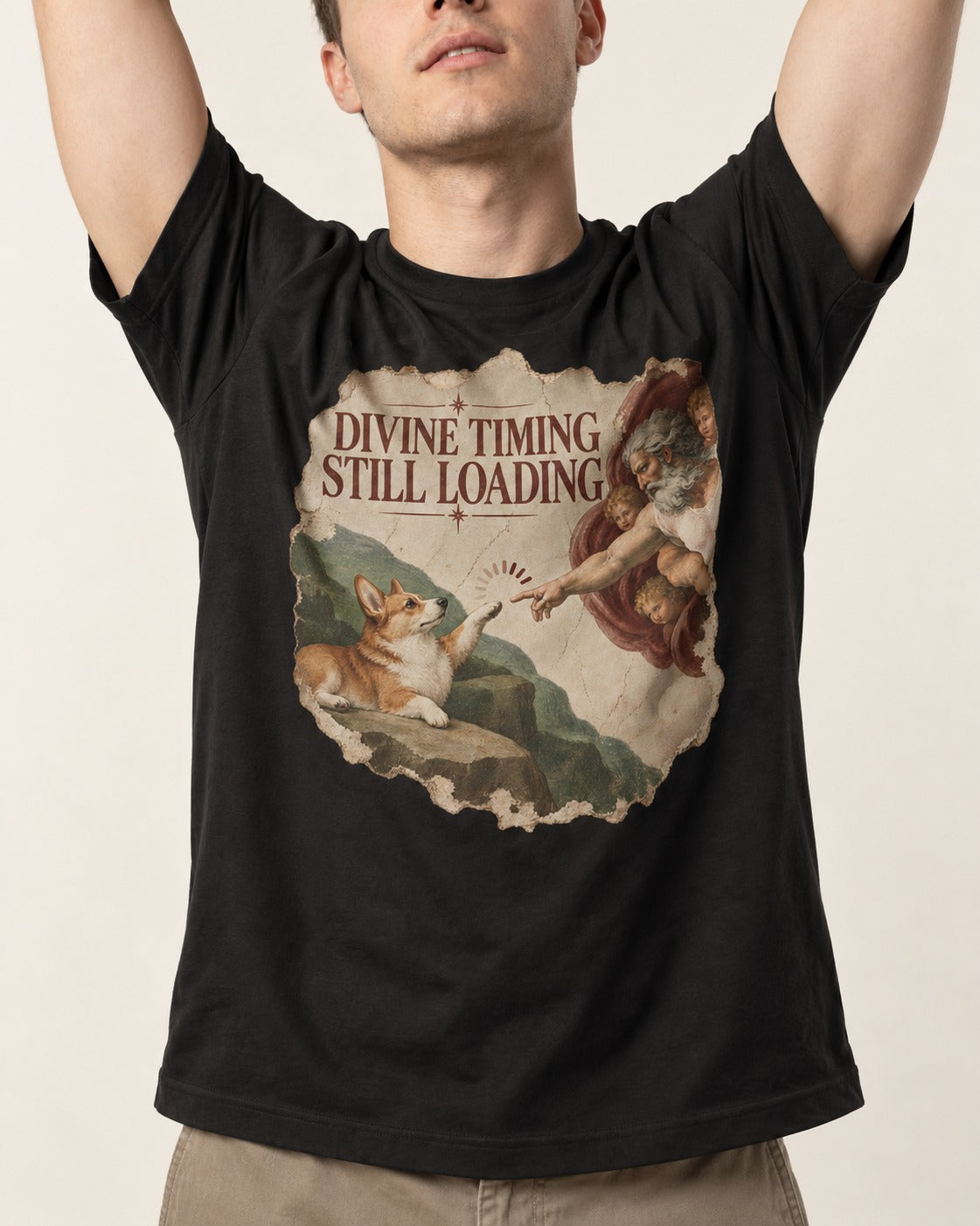 Corgi Divine Timing Still Loading Creation Parody T-Shirt in Black, worn by a model, front view