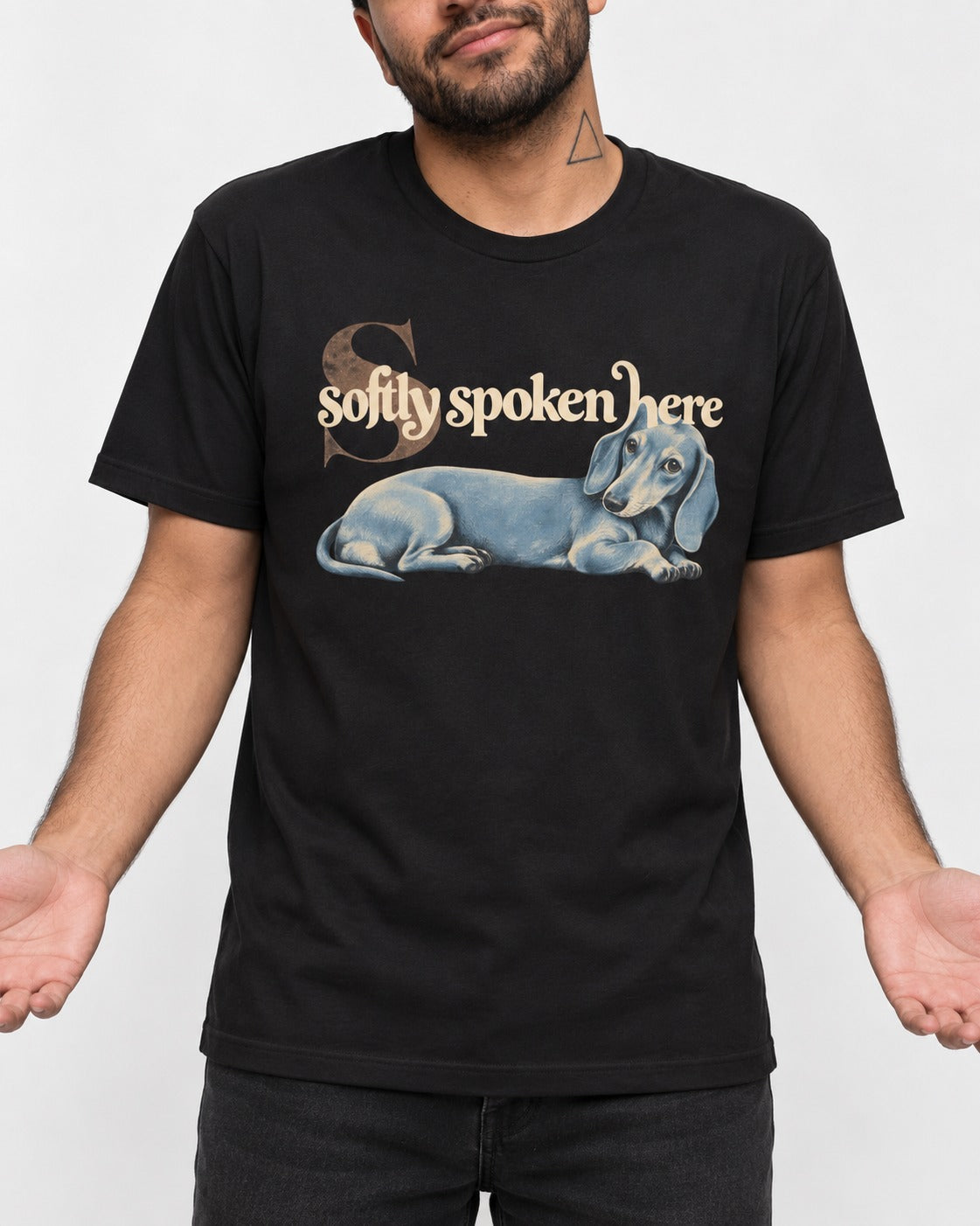 Dachshund Softly Spoken Here Reclining Portrait Graphic T-Shirt in Black, worn by a model, front view