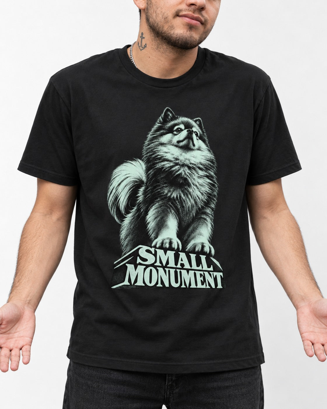 Pomeranian Small Monument Pedestal Graphic T-Shirt in Black, worn by a model, front view