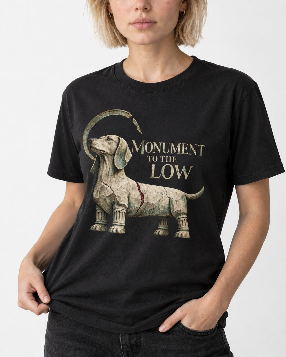 Dachshund Monument to the Low Stone Statue Graphic T-Shirt in Black, worn by a model, front view