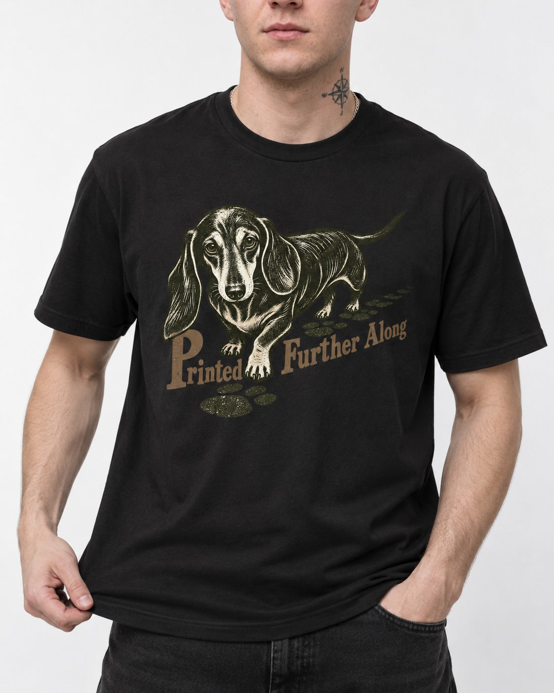 Dachshund Printed Further Along Footprint Graphic T-Shirt in Black, worn by a model, front view