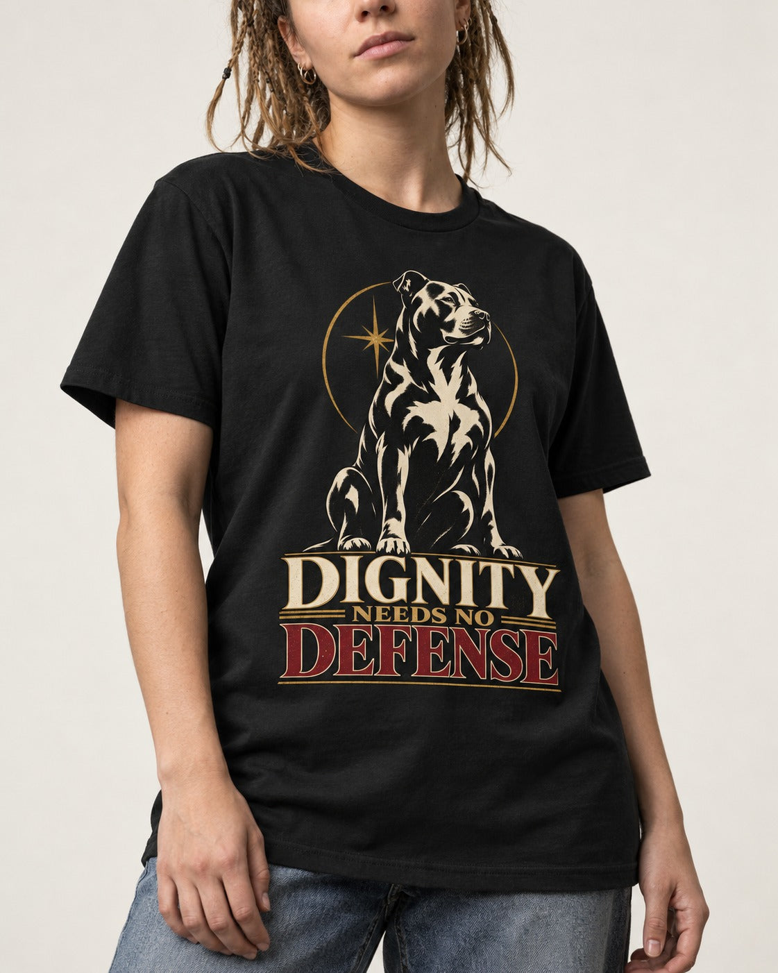 Pitbull Dignity Needs No Defense Seated Emblem Graphic T-Shirt in Black, worn by a model, front view