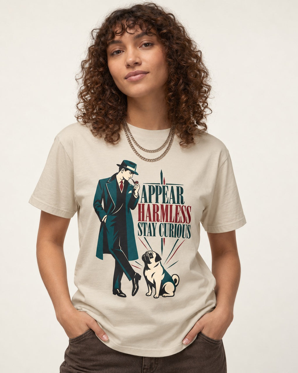 Pug Appear Harmless Stay Curious T-Shirt in Sand, worn by a model
