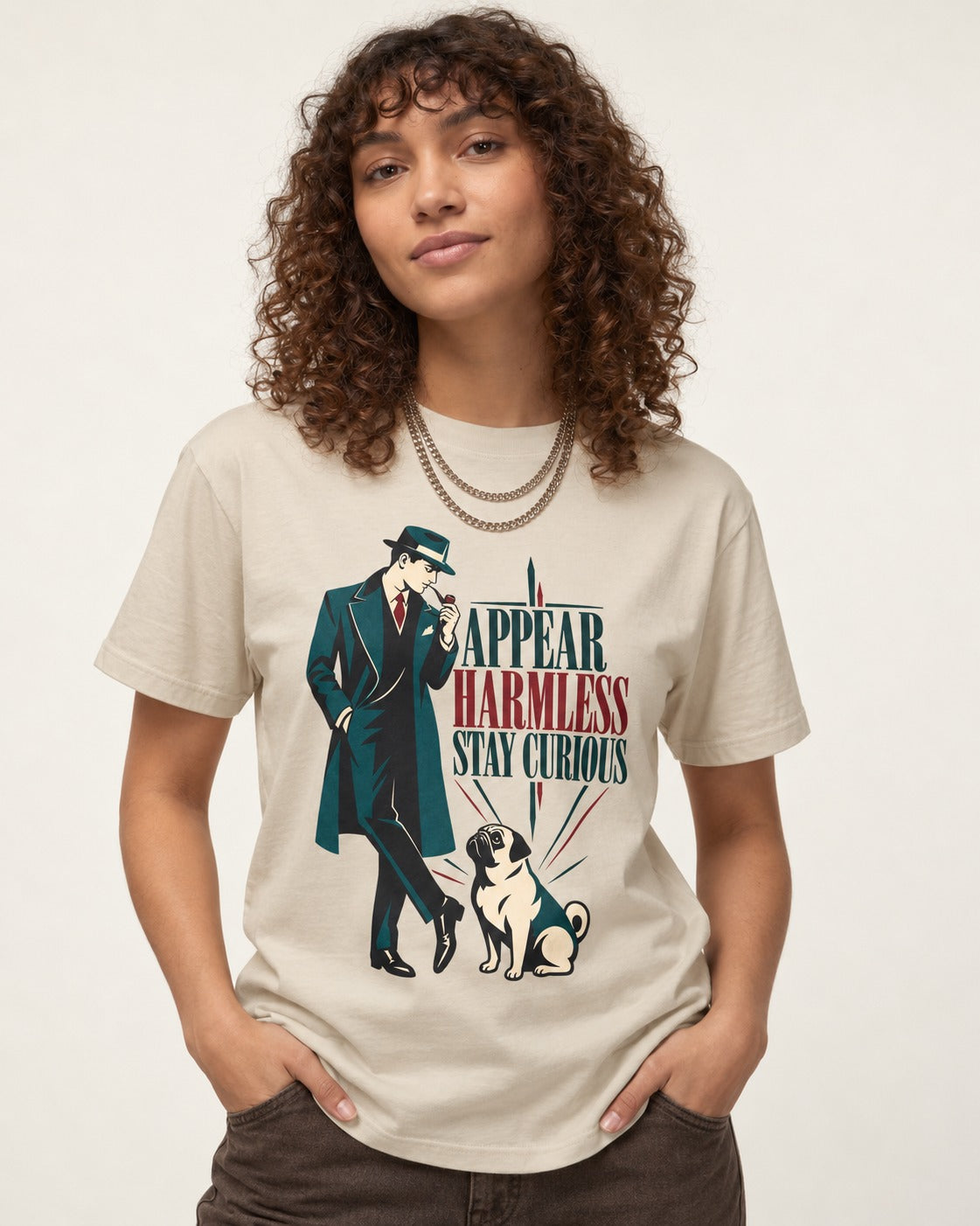 Pug Appear Harmless Stay Curious T-Shirt in Sand, worn by a model