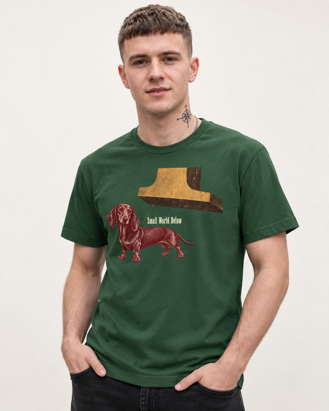 Dachshund Small World Below Giant Shoe Graphic T-Shirt in Forest Green, worn by a model