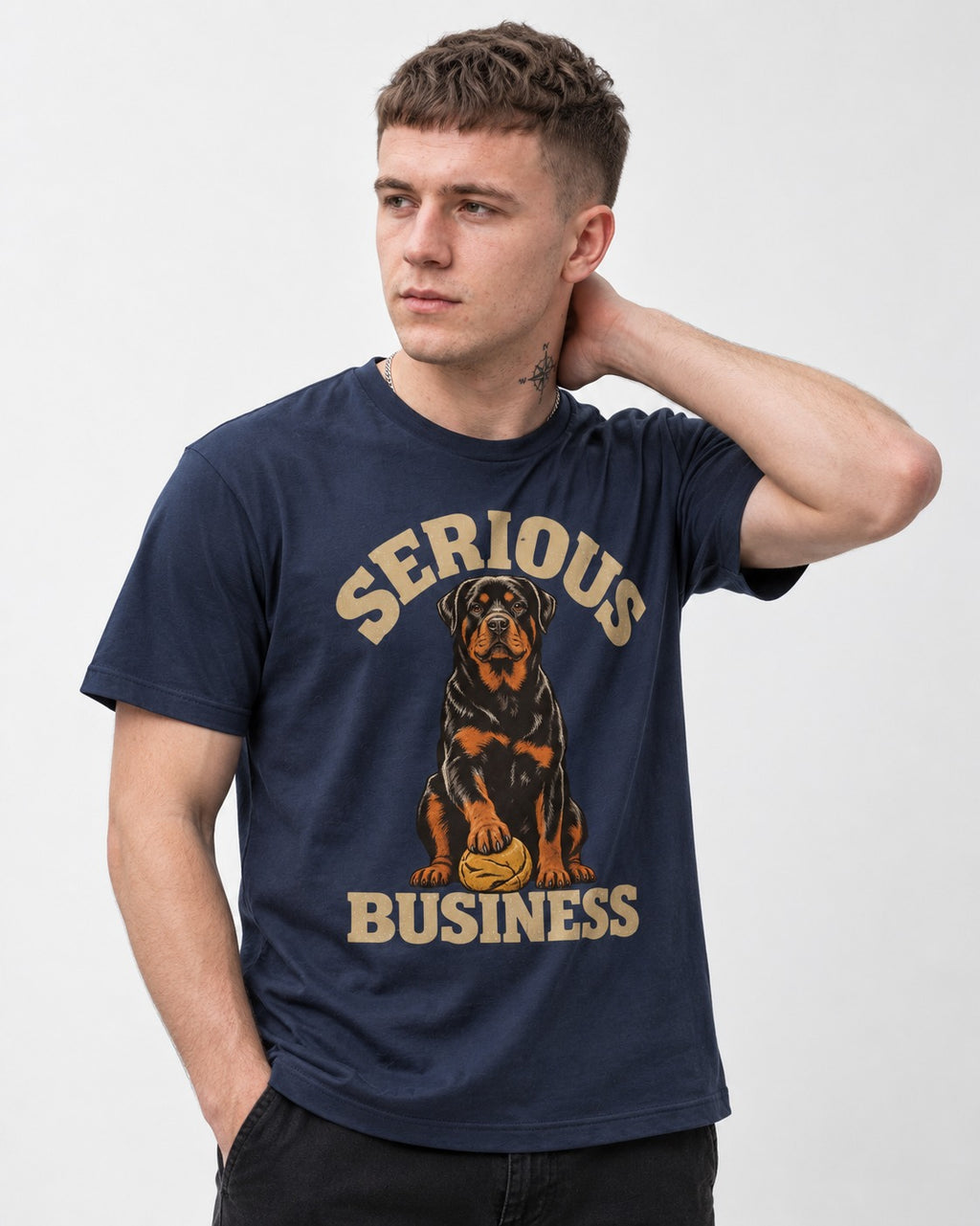Rottweiler Serious Business Ball Under Paw Graphic T-Shirt in Navy, worn by a model
