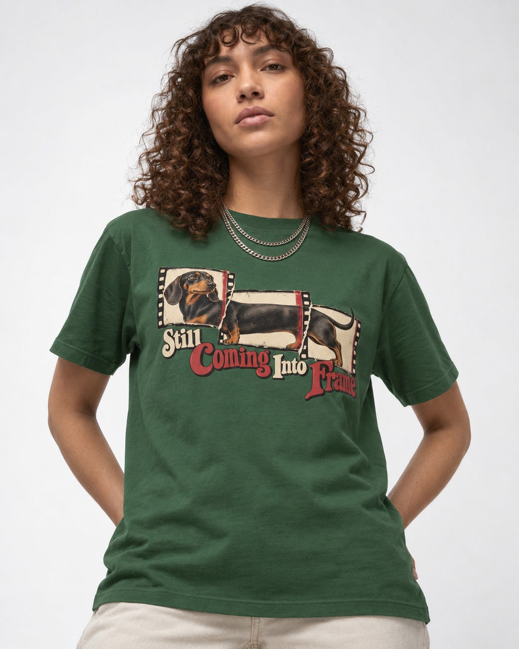Dachshund Still Coming Into Frame Vintage Filmstrip Graphic T-Shirt in Forest Green, worn by a model