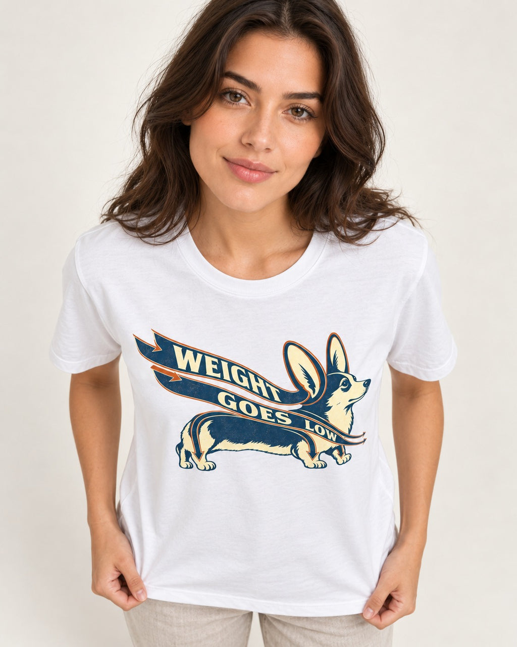 Corgi Weight Goes Low Ribbon Arrow Graphic T-Shirt in White, worn by a model