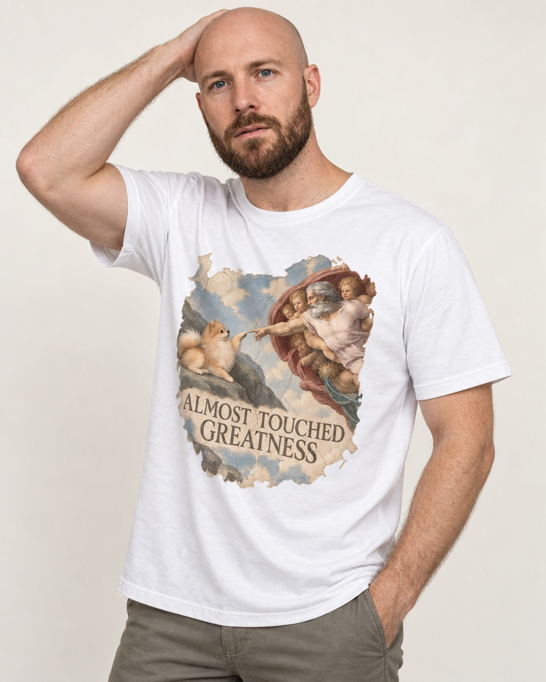 Pomeranian Almost Touched Greatness Fresco Graphic T-Shirt in White, worn by a model