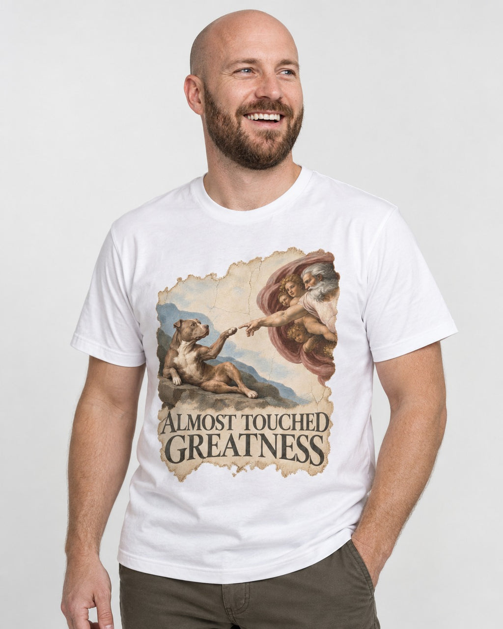 Pitbull Almost Touched Greatness Creation Parody Graphic T-Shirt in White, worn by a model