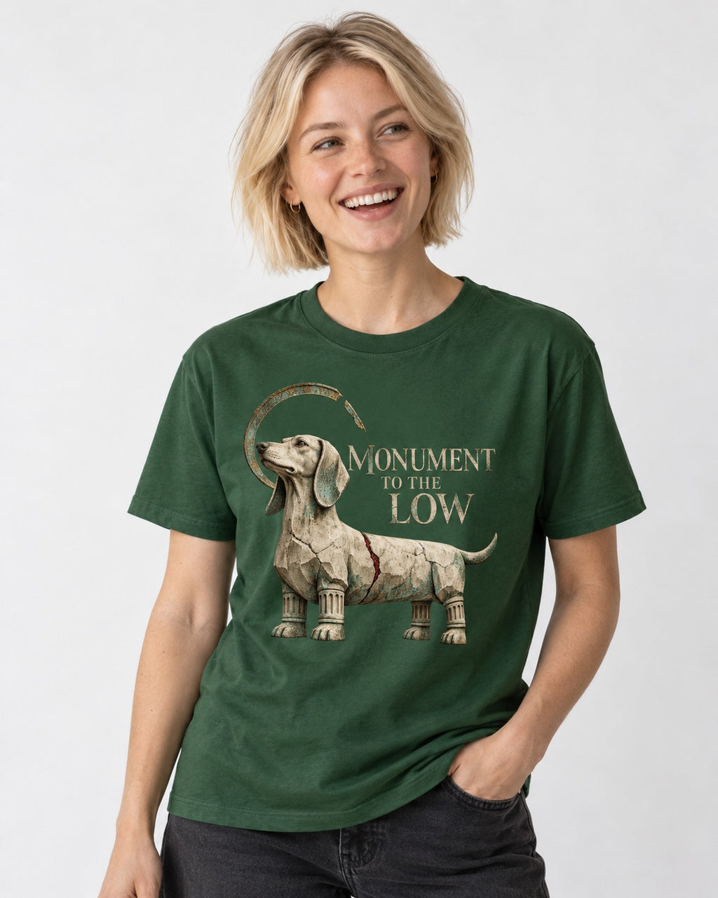 Dachshund Monument to the Low Stone Statue Graphic T-Shirt in Forest Green, worn by a model