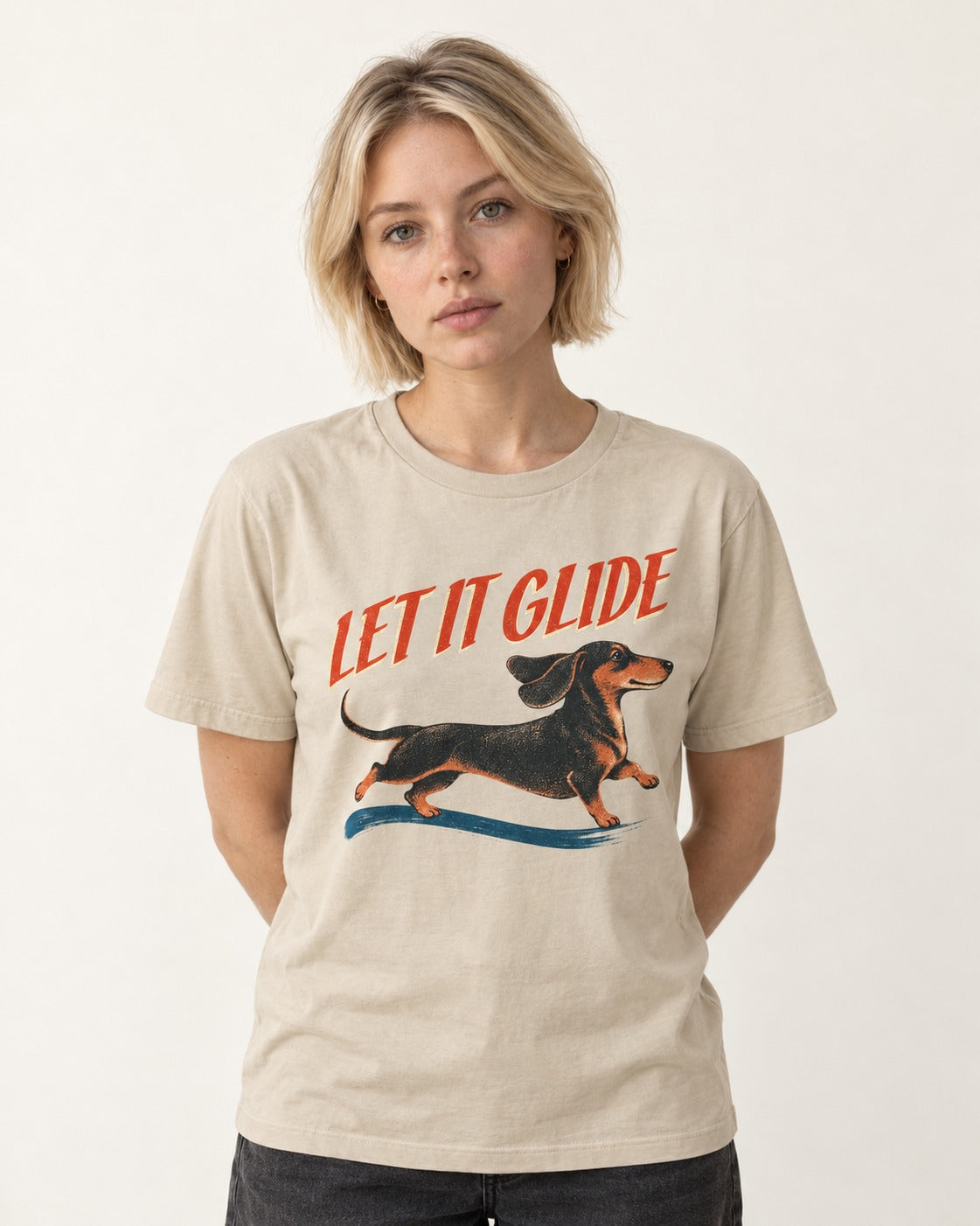 Let It Glide Dachshund T-Shirt in Sand, worn by a model