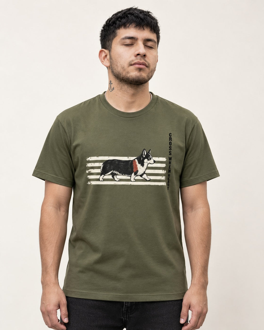 Corgi Cross When Ready Crossing Bars Graphic T-Shirt in Heather Military Green, worn by a model