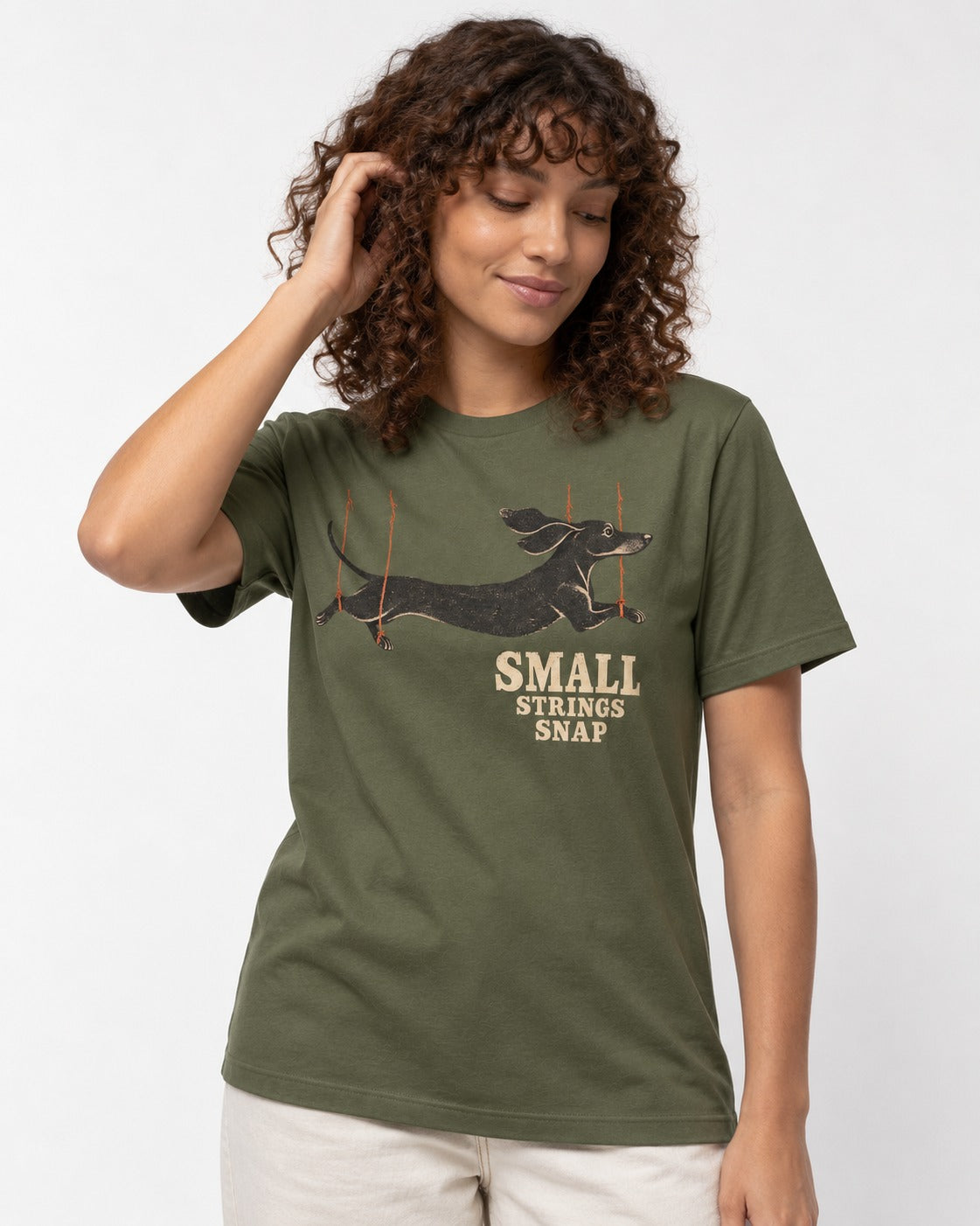 Dachshund Small Strings Snap Marionette Graphic T-Shirt in Heather Military Green, worn by a model